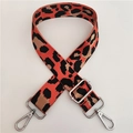 Macro shot of adjustable wide leopard print strap with silver hardware for crossbody bags - Orange With Silver Buckle