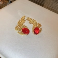 Close-up of golden coral-shaped earrings with red oval gemstone insets for women - Gold Coral Shape Red Gem Style (50#)
