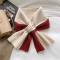 Flat lay of a two-tone beige and deep red knitted winter scarf on white fabric - Burgundy
