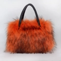 Detail of the high-end faux fur tote bag with orange and black textures and leather handles - Orange