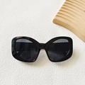 Elegant black cat-eye sunglasses with glossy resin frame and dark gray translucent lenses - Black and Gray