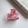 Detail of pink marble acetate hair claw clip with metal spring on white background - 5.2cm / Pink & White
