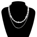 Double-layered necklace featuring white pearls and sparkling square zircon stones on a model - White K/Silver