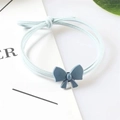 Detail of light blue bow hair tie with triple-strand elastic cord on aesthetic card - Bow / Blue