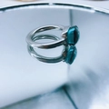 Silver stainless steel ring with emerald green zircon gemstone on reflective surface - Silver Base: Sep-Ink Blue