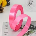 Roll of vibrant hot pink satin ribbon with a smooth silky finish for gift packaging - Rose Pink