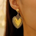 Vintage gold heart earrings with crown detail and sunburst rays on model - Antique Gold Crown Earrings