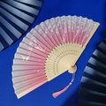 Pink and beige folding fan with cherry blossoms, butterflies and silk tassel on bamboo frame - Pink Gradient Cherry Butterfly