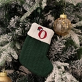 Green knitted Christmas stocking featuring an embroidered red letter O with a Santa hat - Green/Letter O