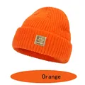 Cozy orange knit beanie for kids with a golden happy face patch and warm cuffed design - S (6-36 Months) / Orange Red