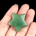 Polished green aventurine quartz star stone held in hand with natural mineral texture - Green Aventurine