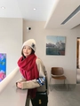 Woman wearing a thick red cashmere winter scarf and beige knit hat for cold weather - Tassel Style / 260g (200x70cm) / Wine Red