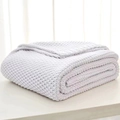 Chunky knit light grey throw blanket with soft tassels and cozy Nordic texture - White