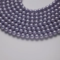 Elegant lavender purple shell pearls with metallic luster in a curved array layout - Purple 6mm/40cm
