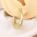 Golden titanium steel hoop earrings with textured grid pattern displayed on model - Rhombus Pattern / Gold