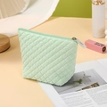 Light green quilted makeup bag with zipper and Why Not charm on table - Trapezoid Bag / Light Green