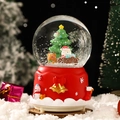 Bola de nieve musical navideña con Papá Noel y renos sobre una base roja decorada - Árbol de Navidad Reno