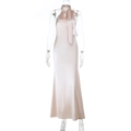 Detailed view of champagne pink halter satin dress featuring backless fishtail design - XS / Apricot