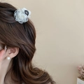 Elegant white fabric flower hair claw and pearl stud earring on curly brown hair - Fabric Flower Style / White