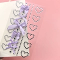 Detailed view of DIY purple ribbon bows and sparkling heart-shaped rhinestone face stickers - BJA-636 (Purple Heart Diamond Bow)