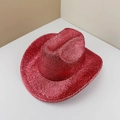 Close-up of a red glitter sequins cowboy hat with sparkling metallic finish for parties - Watermelon red