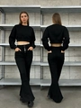 Detail of high-waist flare jeans featuring a multi-button closure and slim fit design - XS / Black