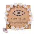 Elastic beaded bracelet with white matte stone beads and golden evil eye charm pendant - 19cm / White Stone