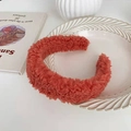 Plush orange faux fur headband with teddy texture displayed on a decorative tray - Burgundy