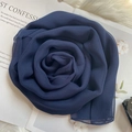 Detail of navy blue chiffon silk scarf creatively folded in a rose shape on soft texture - Navy Blue / 160x50cm