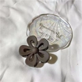 Matte dark brown flower hair claw clip on a decorative tray for elegant hairstyling - Matte Coffee
