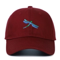 Close-up of a burgundy baseball cap featuring detailed blue and green dragonfly embroidery - Burgundy