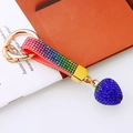 Detailed macro view of rainbow rhinestone leather strap and blue strawberry pendant charm - Sapphire Blue
