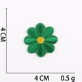 Detail view of a 4cm green floral embroidered patch with fine stitching and sizing - No.26 Green Small Flower