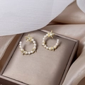 Elegant gold-tone star and crescent moon stud earrings with white pearls and crystals - Star Moon Pearl Rhinestone Style (E4695)