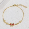 Bracciale a fiocco cuore dorato con gemma rossa a pera e dettagli in zircone - Oro