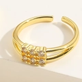 Macro shot of double-layered gold ring featuring a sparkling square zircon cluster focal point - Double Layer White Zirconia Style