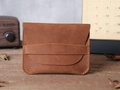Detail of vintage brown leather card holder with hand-stitched seams on wood desk - Red Brown