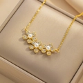 Elegant gold necklace with zircon flower pendants and pearls on a premium jewelry display - Gold