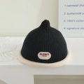 Detail of black knit beanie with white rolled brim and Blience brand patch decoration - Black (Letter Label)