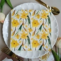 Square floral paper napkin with yellow daffodil print displayed on a white petal plate - Yellow Narcissus (1083)