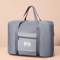 Grey foldable travel storage bag with quilted texture and zipper pocket on a neutral background - Gray