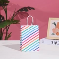 Colorful striped paper gift bag with white handles on a clean minimalist tabletop - Small (21x15x8cm) / Colorful Twill
