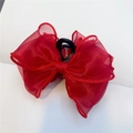 Close-up of a red organza bow hair claw clip with mesh texture and plastic grip - Red Claw Clip