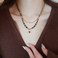 Bohemian double-layer necklace with tiger eye beads and sun pendant on model - Leather Cord Double Layer Sun Pendant (14# Necklace-Coffee)