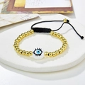 Close-up of handmade gold bead evil eye bracelet with adjustable black braided rope - White Enamel Eyeball Style (221025-B-G-6)