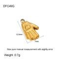 Macro view of a 12.5mm gold palm pendant featuring a heart emboss and polished finish - Gold Hamsa Hand DFC49G