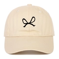 Beige cotton baseball cap featuring black ribbon bow embroidery and classic six-panel design - Beige