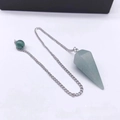 Detail shot of a light green natural crystal hexagonal prism pendant with silver chain - Green Aventurine