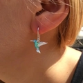 Close-up of hummingbird drop earring with blue gradient enamel worn on a model's ear - E2959 Hummingbird Earrings-Silver