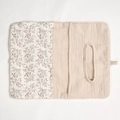 Detail of baby crib organizer showing soft cotton floral fabric and oval tissue opening - Khaki Leaves + Solid Color